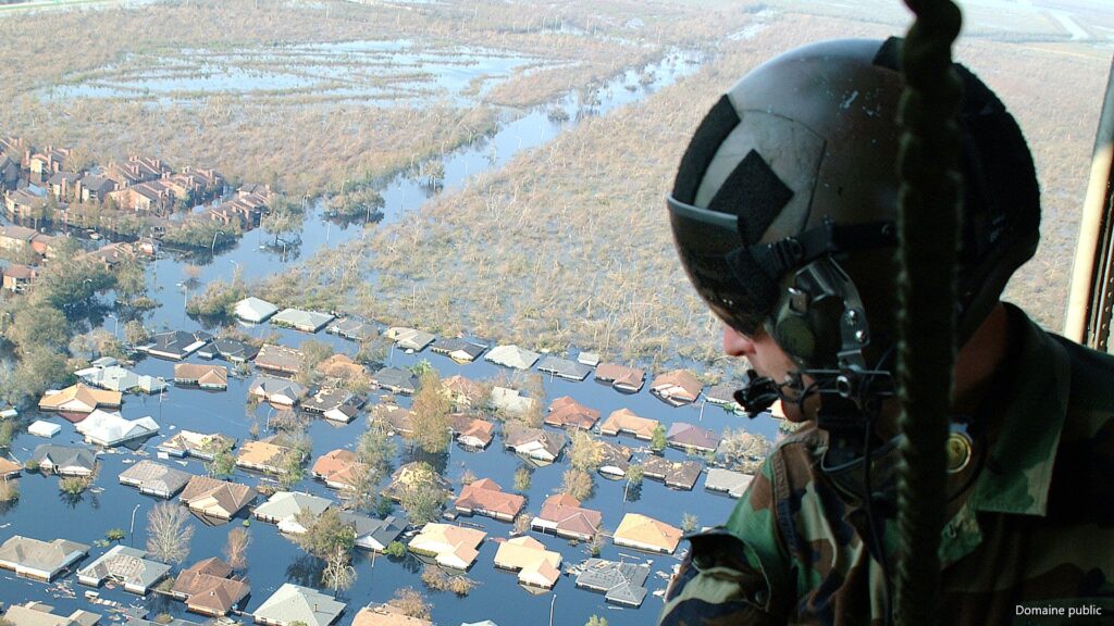 OVER NEW ORLEANS -- Tech. Sgt. Keith Berry looks down into flooded streets searching for survivors. He is part of an Air Force Reserve team credited with saving more than 1,040 people in the aftermath of Hurricane Katrina. He is a pararescueman with the 304th Rescue Squadron from Portland, Ore.