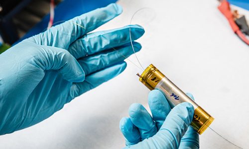 Batterie traversée par une fibre optique en verre de chalcogénure permettant de transporter de la lumière dans le domaine infrarouge. L’interaction cette lumière avec les constituants de la batterie permet d’identifier et de suivre les molécules chimiques présentes autour de la fibre. © Frédérique PLAS / CSE / CNRS Photothèque